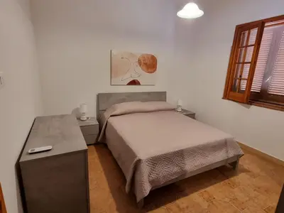 Letto o letti in una camera di Villa Pina Arenella