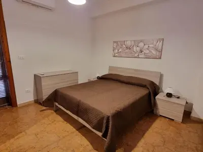 Letto o letti in una camera di Villa Pina Arenella