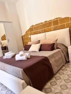 Letto o letti in una camera di B&Beach Ospitalità Siciliana