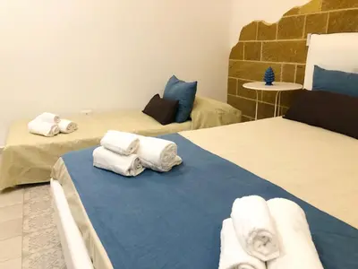 Letto o letti in una camera di B&Beach Ospitalità Siciliana