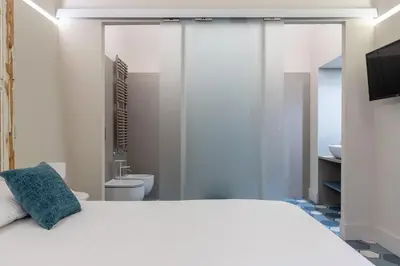 Letto o letti in una camera di Biuti Suite Apartment