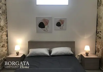 Letto o letti in una camera di Borgata Home - Casa Vacanza Siracusa