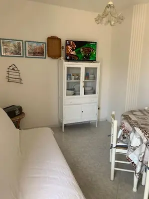 Letto o letti in una camera di Villa Fiori giardino, 400 m. mare con parcheggio