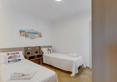 Letto o letti in una camera di Villa Rosimeli con Piscina a 150 mt dal mare