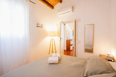 Letto o letti in una camera di Naiadi Apartment Ortigia