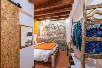 Letto o letti in una camera di Elsa d'Ortigia - I TRE ARCHI