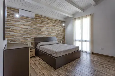 Letto o letti in una camera di Villa Pinella by Villa Plus