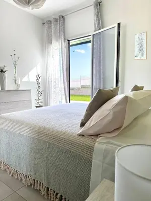 Letto o letti in una camera di Villa Flora, Piscina Esclusiva e Mare