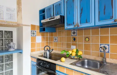 Cucina o angolo cottura di La Gorgone Ortigia Apartments