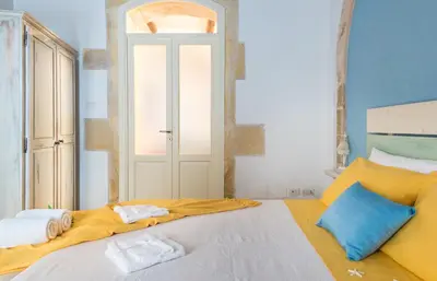 Letto o letti in una camera di La Gorgone Ortigia Apartments
