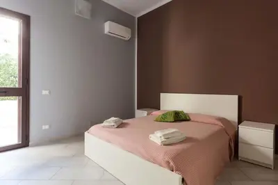 Letto o letti in una camera di Villa con piscina vista mare e Etna