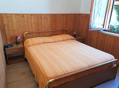 Letto o letti in una camera di Villa Flora: un'oasi verde a 100 m dal mare
