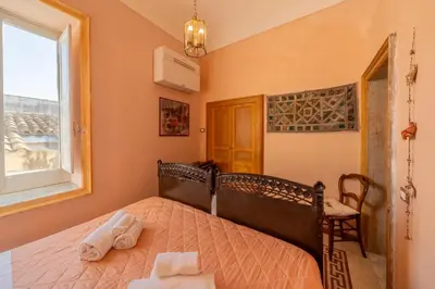 Letto o letti in una camera di Residenza Mistral Ortigia a 2 passi dal mare