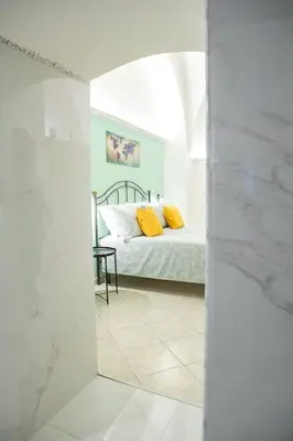 Letto o letti in una camera di Casa Vacanze - I Portici House