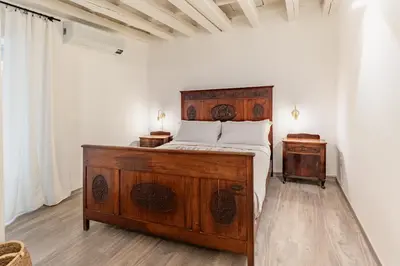 Letto o letti in una camera di Il Cortile sul Vicolo alla Giudecca by Wonderful Italy