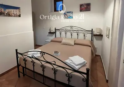 Letto o letti in una camera di Ortigia Ronco 21 - casa vacanza