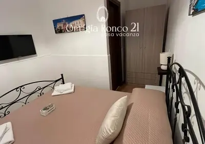 Letto o letti in una camera di Ortigia Ronco 21 - casa vacanza