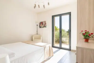 Letto o letti in una camera di Villa Papeda-Tenuta il Cavaliere d'Italia Noto-vista fronte mare e piscina privata