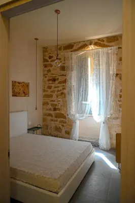 Letto o letti in una camera di ESTIA, ospitalità siciliana