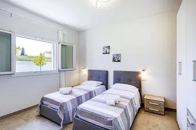 Letto o letti in una camera di Villa Andromeda by Villa Plus