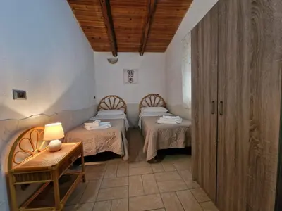 Letto o letti in una camera di Vento del Sud casa vacanze