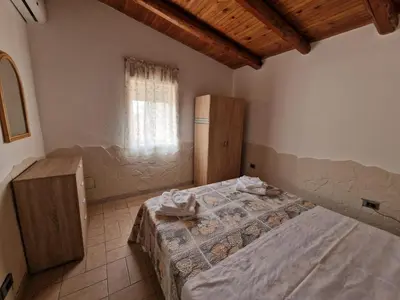 Letto o letti in una camera di Vento del Sud casa vacanze