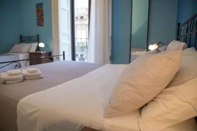Letto o letti in una camera di Catania Inn Rooms