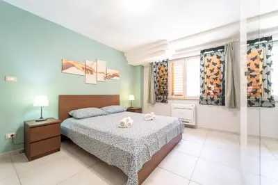 Letto o letti in una camera di GuestHost - Urban Experience Syracuse