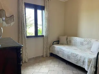 Letto o letti in una camera di Brunello con veranda e piscina condivisa