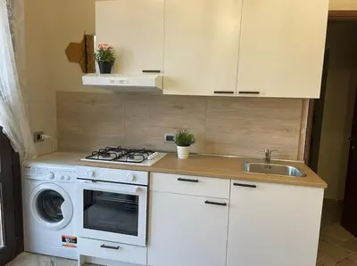 Cucina o angolo cottura di Brunello con veranda e piscina condivisa