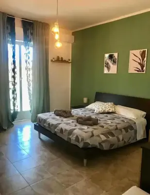 Letto o letti in una camera di Ionio Rooms