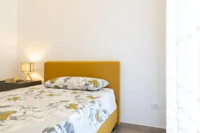 Letto o letti in una camera di GuestHost - Dimora dei Consoli Apartments