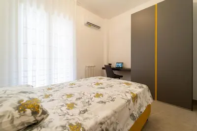 Letto o letti in una camera di GuestHost - Dimora dei Consoli Apartments