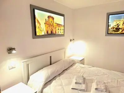 Letto o letti in una camera di Nata Sicula