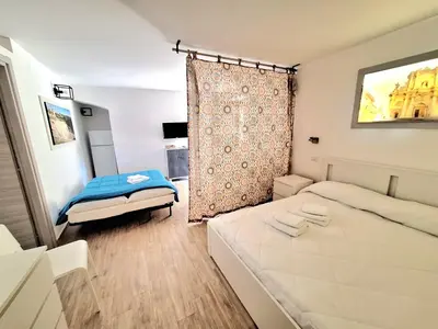 Letto o letti in una camera di Nata Sicula