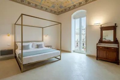 Letto o letti in una camera di Palazzo Pupillo fine apartments by Dimore in Sicily