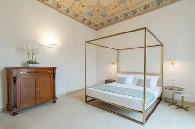 Letto o letti in una camera di Palazzo Pupillo fine apartments by Dimore in Sicily
