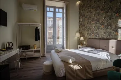 Letto o letti in una camera di Etnea Boutique Hotel