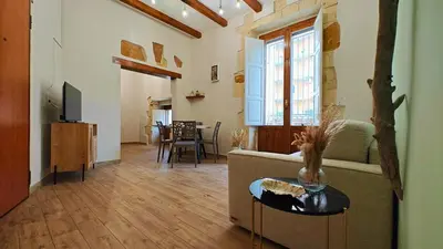 Area soggiorno di Il sussurro delle Nereidi, appartamento boho-chic a Siracusa