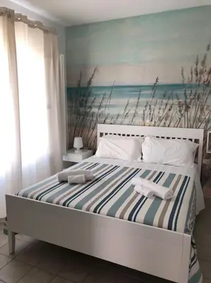 Letto o letti in una camera di Casa da sogno a due passi da spiaggia bandiera blu