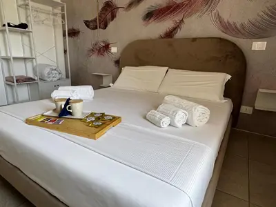 Letto o letti in una camera di Serèsia Rooms Siracusa Centro