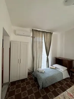 Letto o letti in una camera di Chez Elle - Casa Vacanze due Camere Catania Centro