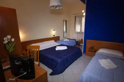 Letto o letti in una camera di Hotel Merlino