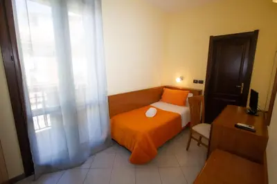 Letto o letti in una camera di Hotel Merlino