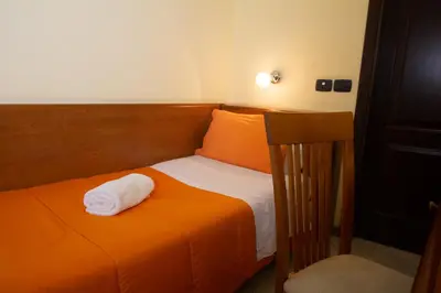 Letto o letti in una camera di Hotel Merlino