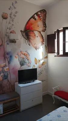 TV o dispositivi per l'intrattenimento presso Hora Guest House by Ortigia Apartments
