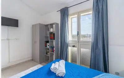 Letto o letti in una camera di villa Gardenia fronte mare x4 apartaments
