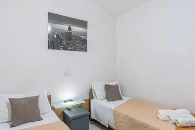 Letto o letti in una camera di villa Gardenia fronte mare x4 apartaments