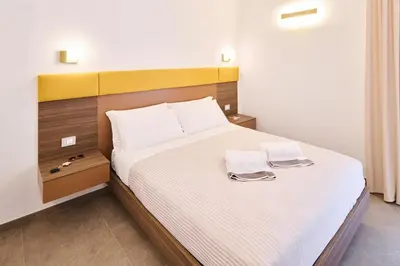 Letto o letti in una camera di San Nicola Rooms Siracusa