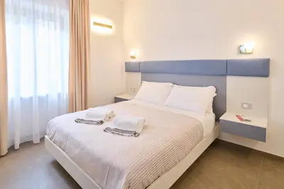 Letto o letti in una camera di San Nicola Rooms Siracusa